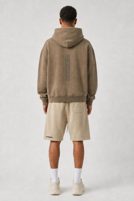 Model wearing SCREEM shorts with camel full-zip hoodie, back view