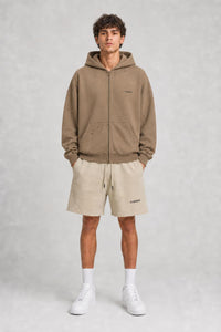 Model wearing SCREEM shorts with camel full-zip hoodie, front view