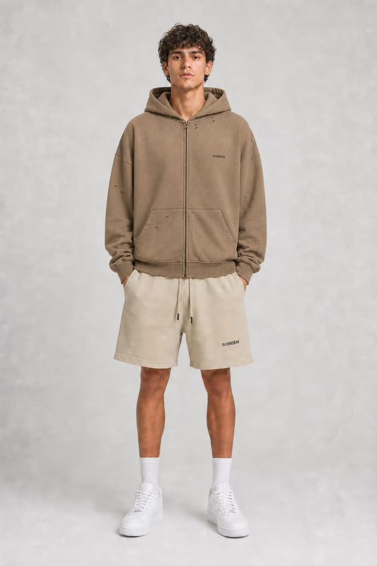 Model wearing SCREEM shorts with camel full-zip hoodie, front view