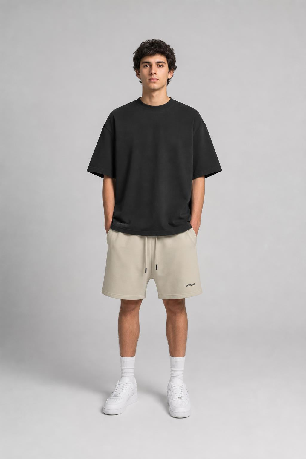 Model wearing SCREEM Washed Tee and shorts, front view