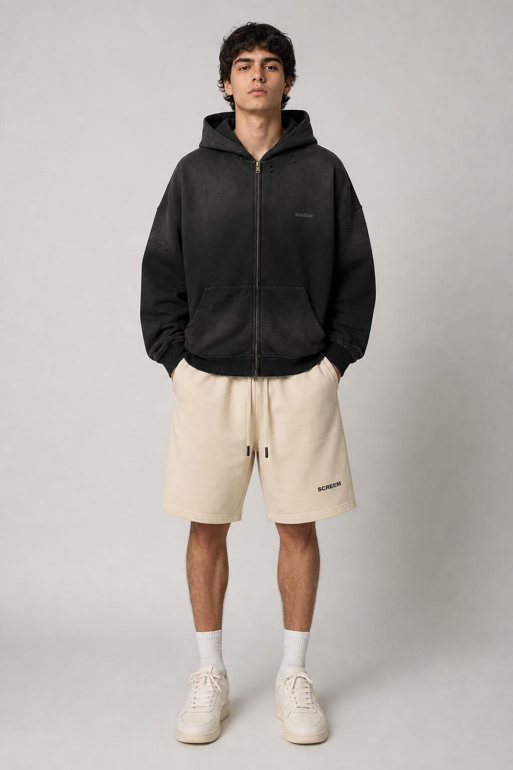 Model wearing SCREEM Full-Zip Hoodie with camel shorts, front view