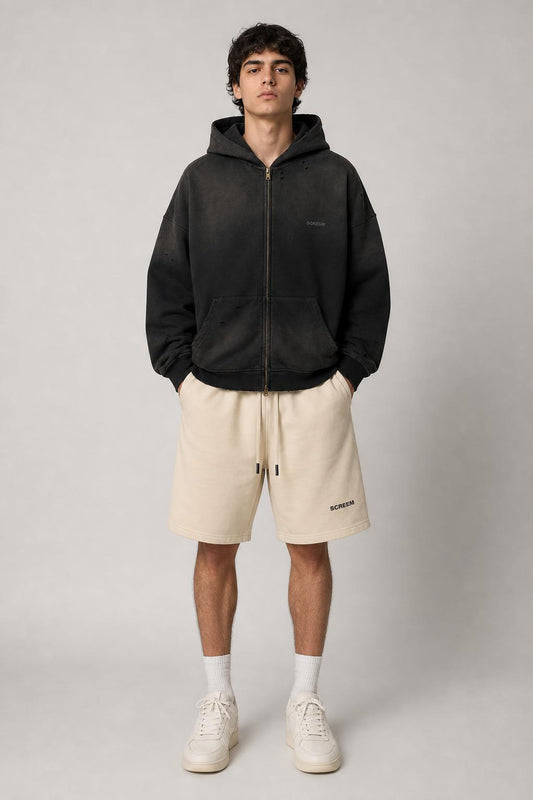 Model wearing SCREEM Full-Zip Hoodie with camel shorts, front view